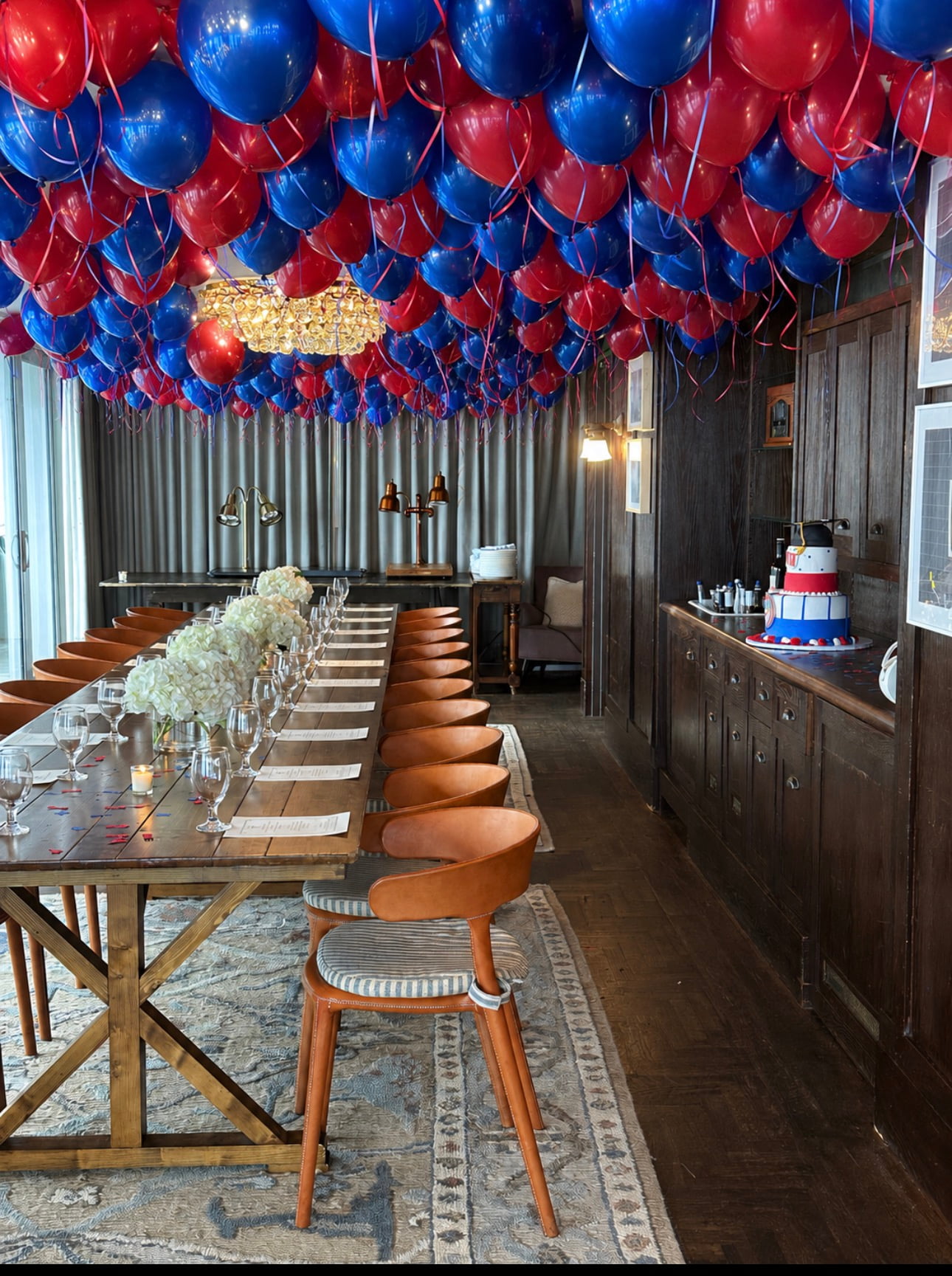 Corporate dinner with red and blue ceiling balloon installation