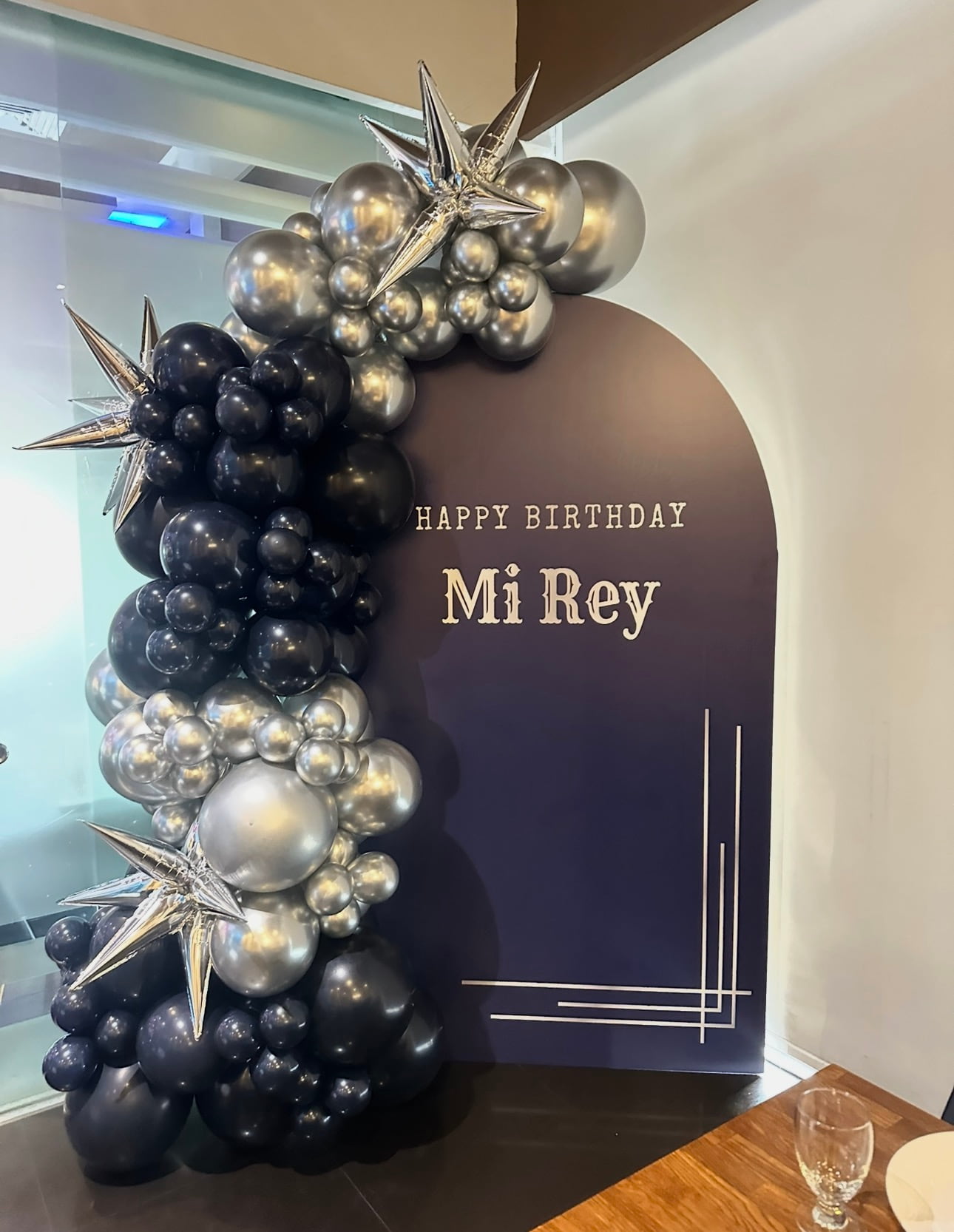 Black and silver luxury birthday balloon backdrop with chrome starbursts