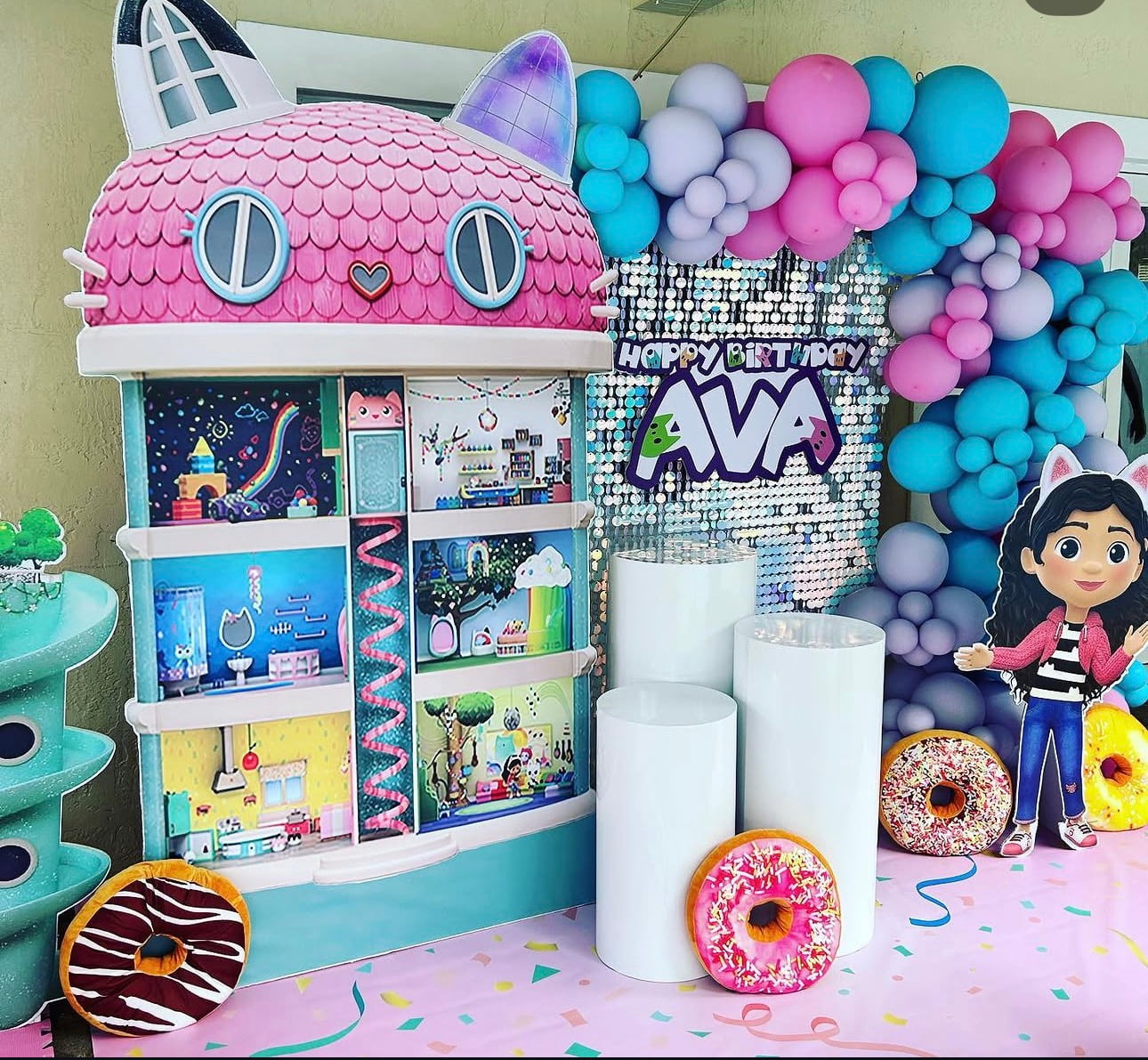 Colorful dollhouse birthday setup with pink, blue and lavender balloons